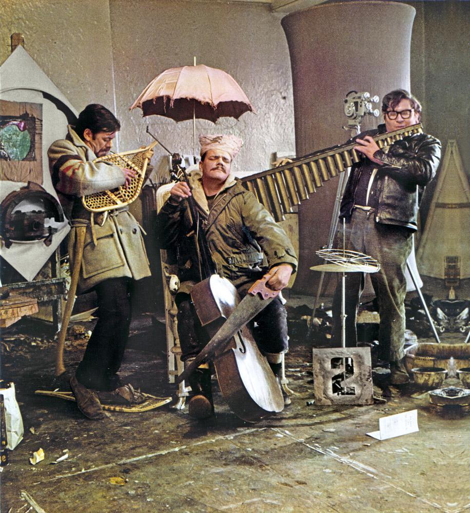 Art Canada Institute, Photograph, Graham Coughtry, Gordon Rayner, and Robert Markle parody the Artists’ Jazz Band in Rayner’s Toronto studio, 1965